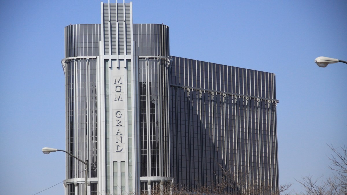 MGM Grand Detroit hotel exterior photographed against a blue sky.
